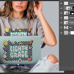 May include: A light gray t-shirt with the words "EIGHTH GRADE" in a retro design, along with smiley faces, lightning bolts, and other graphics. The design is on a laptop. The person is wearing glasses.