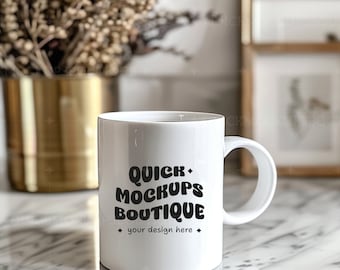 May include: White ceramic mug with a black design that says "Quick Mockups Boutique" and "your design here". The mug is sitting on a white marble surface.