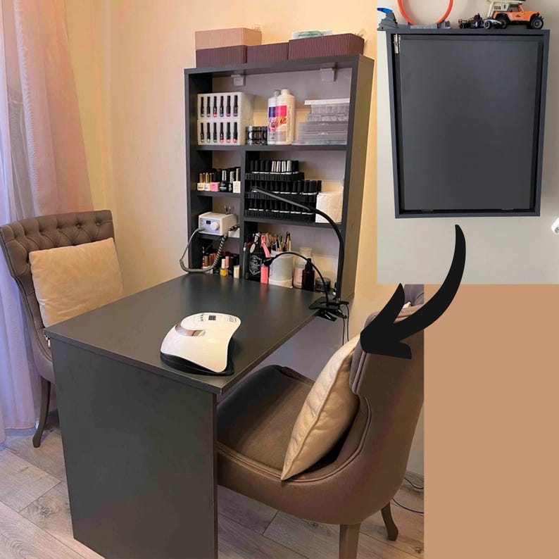 May include: A black desk with a white lamp and a black shelf unit with various bottles and jars. The shelf unit has a black cabinet door on the top. There are two chairs with brown upholstery and a white cushion.