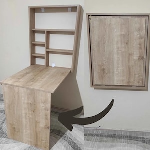 May include: A light wood folding desk with a shelf unit above it. The desk is folded down and the shelf unit is attached to the wall. The desk is shown in the folded down position and then in the unfolded position.