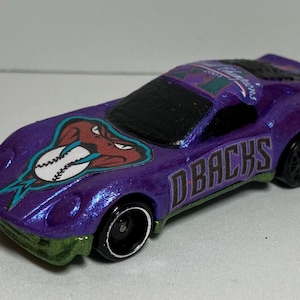 May include: Purple toy car with a baseball and snake graphic and the words "D-backs" on the side.