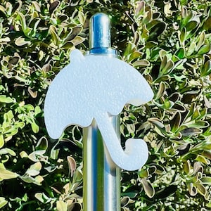 May include: White plastic umbrella-shaped bottle stopper. The stopper is attached to a silver metal bottle.