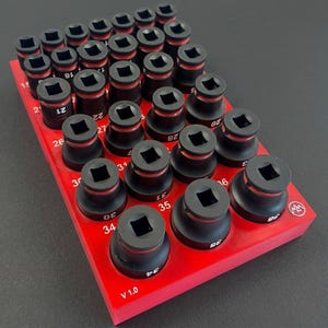 May include: A red socket organizer tray holding a set of black sockets with red accents. Each socket is labeled with a number. The tray has the text "V 1.0" printed on it.