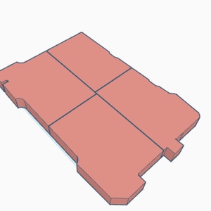 May include: A salmon-coloured, rectangular object with a blue outline, divided into four sections by dark blue lines. The object has a unique shape with cut-out sections on the sides and corners, giving it a distinct design.