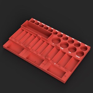 May include: A red plastic tool organizer tray featuring multiple circular and rectangular slots for drill bits or sockets. The tray includes white printed fractional inch labels ranging from 1/4 to 1, including 9/32, 5/16, 11/32, 3/8, 7/16, 1/2, 9/16, 5/8, 11/16, 3/4, 13/16, and 7/8.