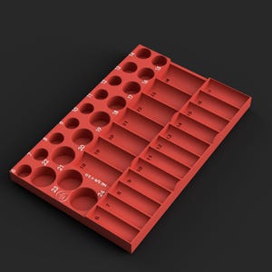 May include: A red rectangular tool organizer tray featuring multiple circular and rectangular slots for sockets and accessories. The tray includes embossed numerical labels from 6 to 24 and the text Mil 3/8 V 3.0 printed on the surface.