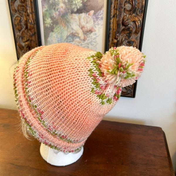 Toboggan designed with spring colors. Peach, green,and pale peach yarn