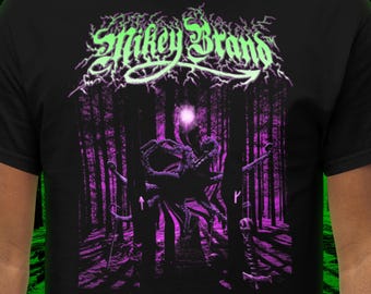 May include: Black t-shirt with a graphic design featuring a forest scene with a creature and the text "Mikey Brand" and "Gateway to Madness" in neon green and purple.