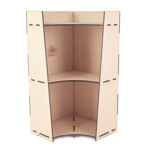 May include: A light-colored, wooden corner shelf unit with two shelves. The unit has a curved front and is designed to fit into a corner. The wood has a natural finish, and the edges are outlined in black. A logo is visible on the side.