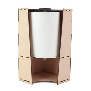 May include: A wooden paper towel holder with a natural finish. The holder has a geometric design with a large roll of white paper towels inside. The holder is open on the front and sides, allowing easy access to the paper towels.