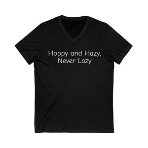 May include: Black V-neck t-shirt with the text "Hoppy and Hazy, Never Lazy" printed in white.
