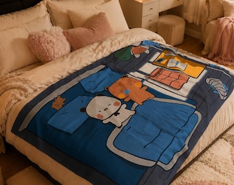 May include: A blue blanket with a cartoon illustration of two bears sleeping in a bed. The blanket is on a bed with white bedding and pillows. The room has a cozy, warm atmosphere with soft lighting and a rug.