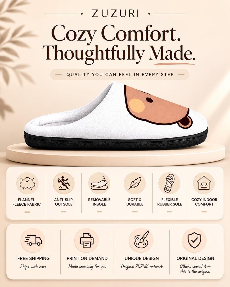 May include: White slipper with a black sole and a cartoon bear face. The text on the image says "Cozy Comfort. Thoughtfully Made." Features include flannel fleece fabric, anti-slip outsole, and a flexible rubber sole.