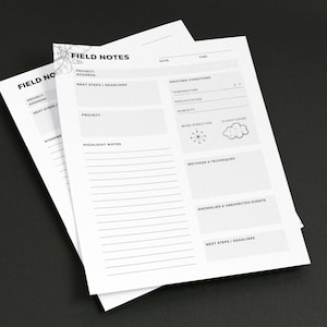 May include: White field notes sheets with the text "FIELD NOTES" and sections for project details, weather conditions, and notes. The sheets are stacked on a dark surface.
