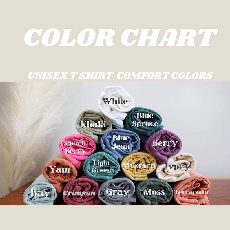 May include: A color chart of unisex t-shirt colors. The colors are arranged in a pyramid shape with the lightest color at the top and the darkest color at the bottom. The colors are: White, Khaki, Crunch Berry, Yam, Bay, Crimson, Gray, Moss, Terracotta, Blue Spruce, Blue Jean, Berry, Light Green, Mustard, Ivory.