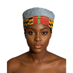 May include: A denim hat with a colorful patterned band. The band features a vibrant mix of red, yellow, green, and black geometric shapes. The hat is worn by a person with dark skin and a neutral expression.
