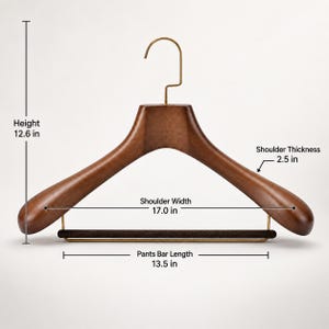 May include: A dark brown wooden clothes hanger with a gold-toned metal hook and a velvet-covered pants bar. Dimensions are 12.6 inches in height, 17.0 inches in shoulder width, 2.5 inches in shoulder thickness, and a 13.5-inch pants bar length.
