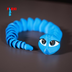 Op de afbeelding: Een blauwe, gesegmenteerde, flexibele speelgoed slang met een cartoon gezicht en grote ogen. De slang is opgerold in een cirkel.