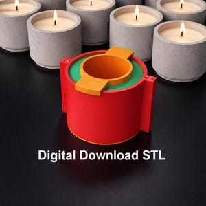 May include: A red, orange, and green cylindrical object with the text "Digital Download STL" in white. The object has a circular opening and a rectangular extension. Several lit grey candles are in the background.