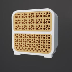 K&ouml;nnte beinhalten: Ein wei&szlig;-beiger Schrank mit zwei Schubladen. Jede Schubladenfront weist ein Muster aus gleichm&auml;&szlig;ig verteilten L&ouml;chern auf. Der Schrank hat abgerundete Ecken und steht auf einem kleinen Sockel. Der Hintergrund ist ein dunkles Grau.