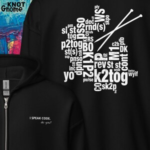 Puede incluir: Sudadera con capucha negra con texto blanco "I SPEAK CODE. do you?" y un gráfico de términos de tejido y agujas. La sudadera tiene cremallera y una etiqueta GILDAN.