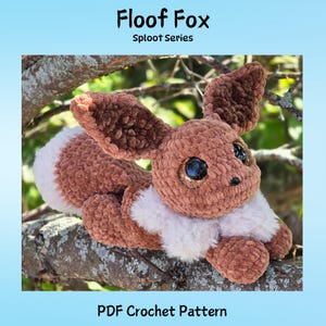 May include: A brown and white crocheted fox plush toy with large ears and sparkling eyes. The plush is lying on a tree branch. The image includes the text "Floof Fox Sploot Series" and "PDF Crochet Pattern".