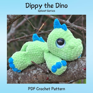 May include: A green crocheted dinosaur toy with blue details, including spikes and feet. The toy has large, reflective eyes and is lying on a tree branch. Text at the top reads "Dippy the Dino" and "Sploot Series." The bottom text says "PDF Crochet Pattern."