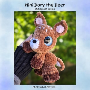 May include: A brown crocheted plush deer toy with large blue eyes, white spots on its head, and pink inner ears. The text Mini Dory the Deer, Mini Sploot Series, and PDF Crochet Pattern are printed on the image in black lettering.