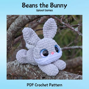 May include: A crocheted grey bunny with large blue eyes, a pink nose, and white accents. The bunny is lying on a tree branch. Text at the top reads "Beans the Bunny, Sploot Series." The bottom text says "PDF Crochet Pattern."