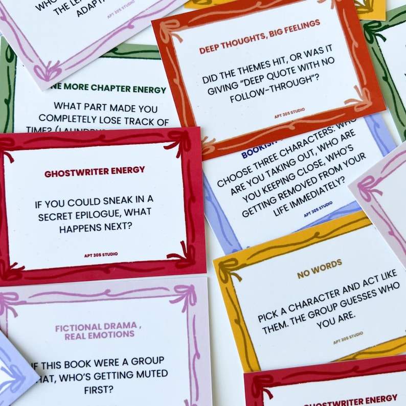 May include: A collection of colorful cards with various prompts and questions. Each card has a white background with text, framed by different colored borders, including red, orange, yellow, and purple. The cards are designed for interactive games or discussions.