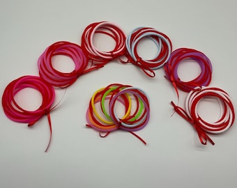 Set of Ten Red and Bright Pink, Light Blue, Light Pink, Light Purple, Light Rainbow, Pink & White 80s Jelly Bracelets Wrapped In A Satin Bow