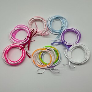 Set of Ten White and Bright Pink, Light Blue, Light Pink, Light Purple, Light Rainbow and Pink 80s Jelly Bracelets Wrapped In A Satin Bow