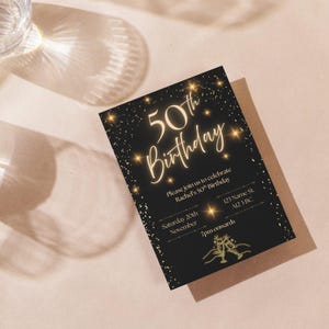 May include: A black 50th birthday invitation with gold text and accents. The invitation includes the text "50th Birthday", event details, and a champagne glass illustration. The invitation is on a light pink surface with shadows.