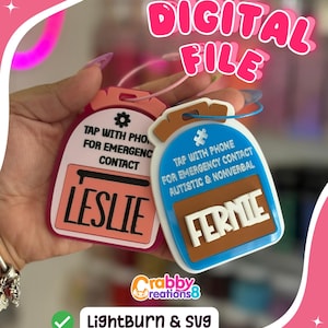 May include: Two personalized emergency contact tags. One is pink with the name "Leslie" and the other is blue with the name "Fernie". Both tags have text that reads "Tap with phone for emergency contact". The image also includes the text "Digital File".
