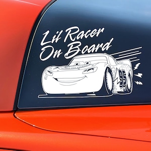 May include: White vinyl decal with the text "Lil' Racer On Board" and a cartoon image of a red race car with the number 95 on the side.
