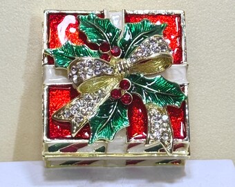 Festive Christmas gift-box jewelry holder with sparkling bow and holly design. Perfect for holiday gifts, décor, and adorable stocking stuff