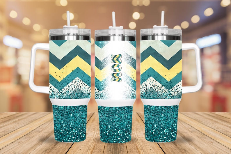 May include: Three stainless steel tumblers with a teal glitter bottom and a white band. The tumblers have a chevron pattern in yellow, white, and teal. One tumbler has the word "MOM" in yellow and teal on the front.