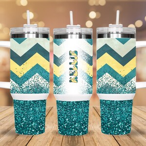 May include: Three stainless steel tumblers with a teal and yellow chevron pattern and teal glitter. The middle tumbler has the name "Kellie" written on it.
