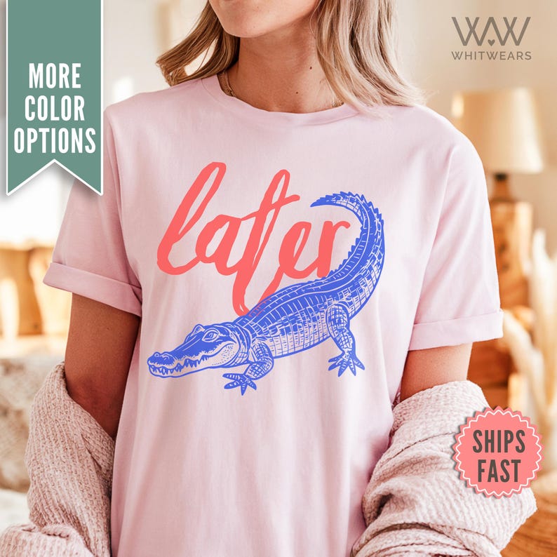 May include: Pink t-shirt with a blue alligator and the word "later" in red.