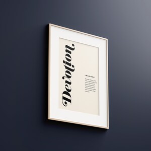 May include: A framed print with the word "Devotion" in a stylized font. The print includes a definition of the word, which reads: "A state of mind that produces a willingness of the soul to acknowledge a higher power and to surrender to its influence with absolute trust, loyalty and faithfulness. It is a state of mind that becomes a virtue, while it produces a spiritual energy that becomes evident in our relationships."