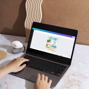 May include: A laptop computer with a white background displaying a tropical themed party invitation with the text "Let's party" and "Alice" on the screen. The invitation has a blue and green colour scheme with palm trees and a beach scene.