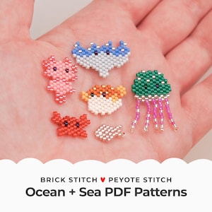 May include: A selection of beaded sea creatures, including an axolotl, crab, jellyfish, and fish, in various colours. The image also includes a blue and white shark, and a pufferfish. The text at the bottom reads "Ocean + Sea PDF Patterns".