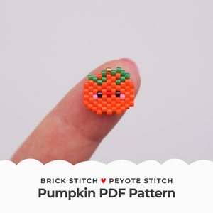 Puede incluir: Una pequeña calabaza naranja con un tallo verde y una cara linda, hecha con cuentas. La calabaza está siendo sostenida por un dedo. El texto "Brick Stitch ♥ Peyote Stitch Pumpkin PDF Pattern" está debajo de la imagen.