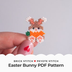 May include: A small, pixelated Easter bunny made of beads, holding an orange carrot. The bunny is brown, white, and orange, with green carrot leaves. The text "Easter Bunny PDF Pattern" is below the bunny.