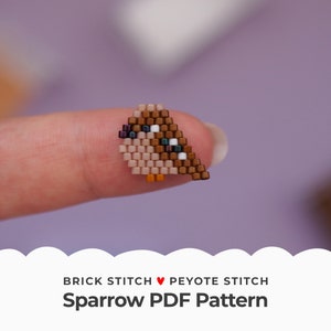 May include: A small brown and beige beaded sparrow, created using brick stitch and peyote stitch, is held on a finger. The sparrow has black eyes and a white beak. The image includes the text "Brick Stitch ♥ Peyote Stitch Sparrow PDF Pattern".