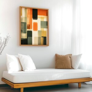Framed Canvas depicting a mid-century modern abstract Artwork is hanging on a wall. Geometrical warm colors. Bauhaus inspired painting.