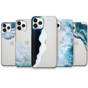 May include: Four clear phone cases featuring various ocean wave designs. The cases are transparent, showcasing the phone's camera lenses. The designs are in different shades of blue and white.