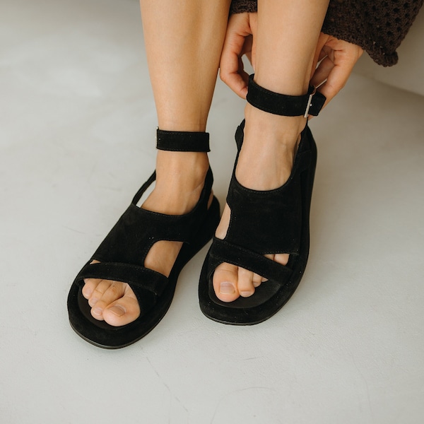 Black sandals, slingbacks on straps, shoes made of natural suede. Sandals with open toe. Sandals with buckle. Comfortable sandals