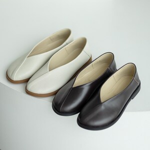 Milk embossed leather flats with wide toe design.