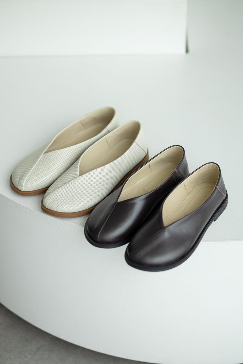 Milk embossed leather flats with wide toe design.
